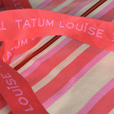Durable red and pink handles on the Peony Pink TATUM LOUISE bag. 
