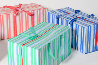 TATUM LOUISE bags in Marina Blue, Grasshopper Green, and Peony Pink with bright red zippers. 