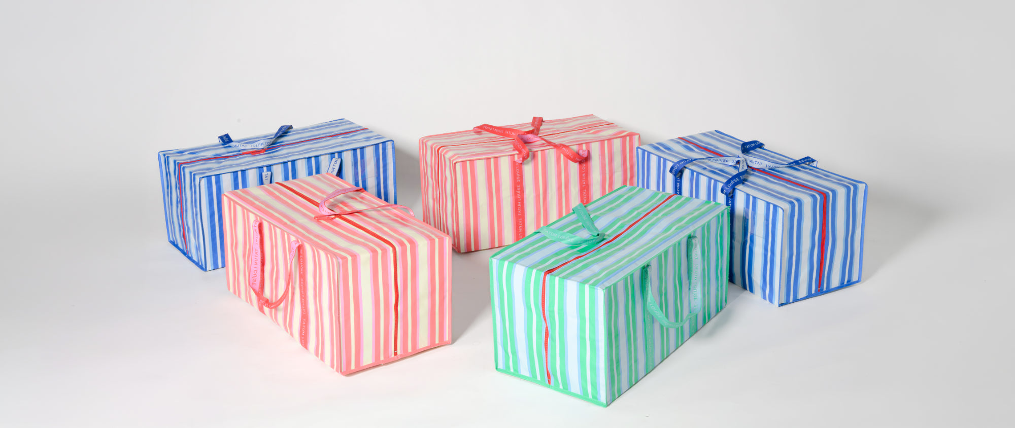 Five striped TATUM LOUISE moving bags in stylish and cute blue, pink, green, and red on a white background