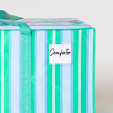 Striped blue and white dorm moving bag with water-resistant label holder.
