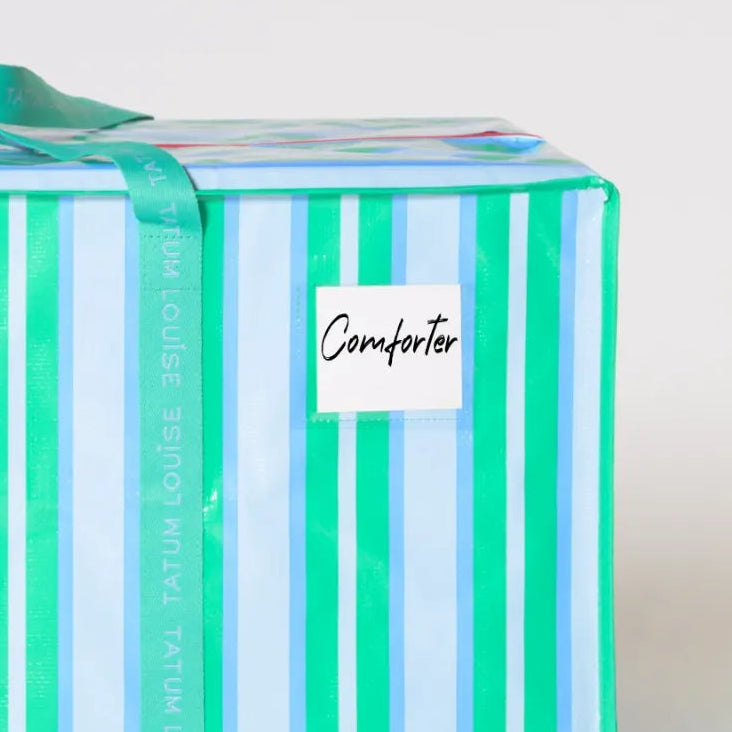Striped blue and white dorm moving bag with water-resistant label holder.