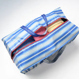 Blue and white striped moving bag with a red zipper on a white background