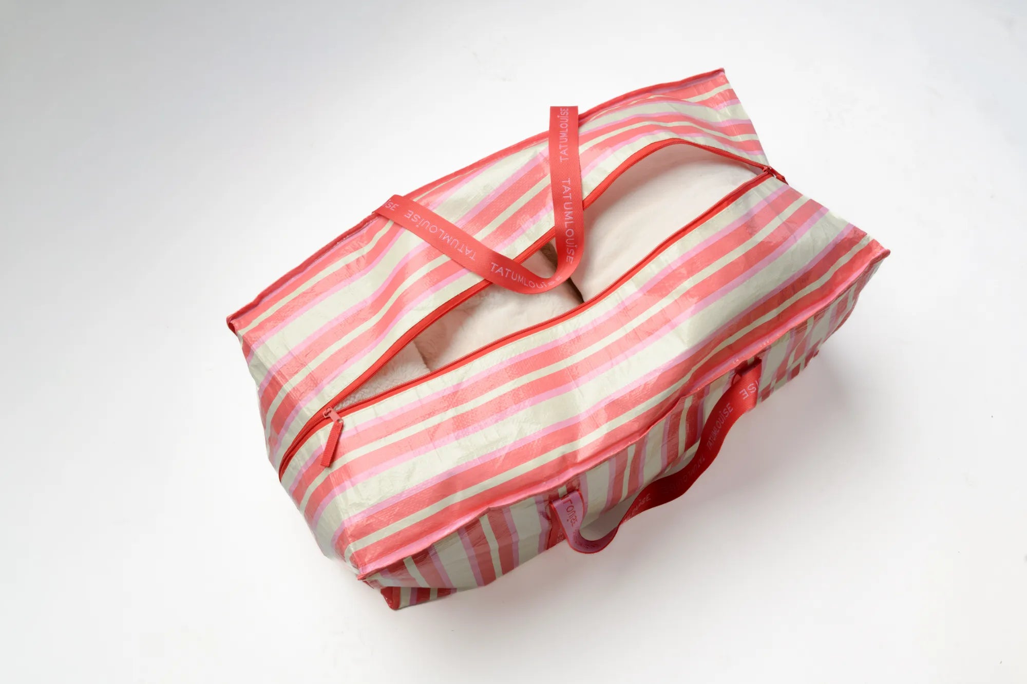 Striped TATUM LOUISE reusable moving bag with red straps on a white background 