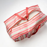 Striped TATUM LOUISE reusable moving bag with red straps on a white background 